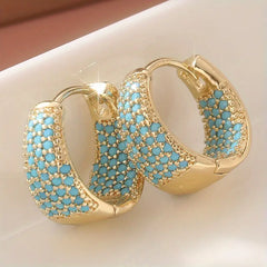Gold-tone hoop earrings with turquoise beaded lattice and scalloped edges, front view