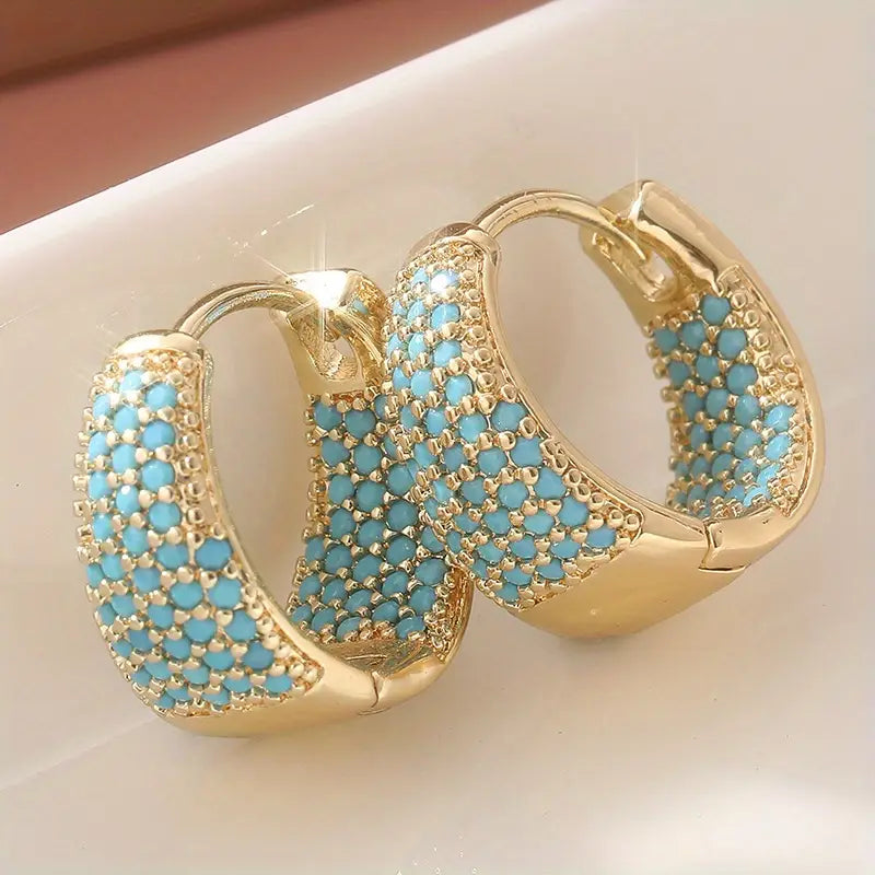 Gold-tone hoop earrings with turquoise beaded lattice and scalloped edges, front view