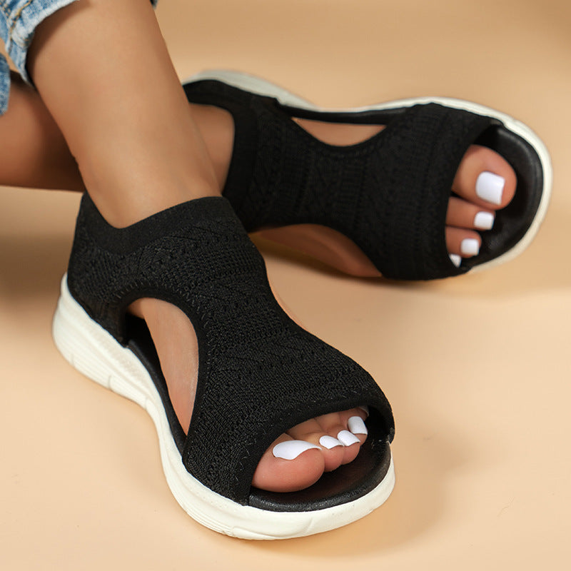 Black knit slingback sandals with open toe and white cushioned sole
