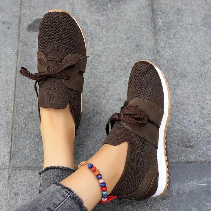 Brown comfort sneakers with lace-up straps and textured knit upper.