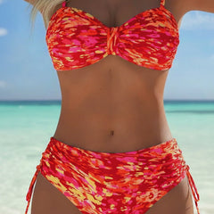 Red abstract print bikini set with underwire push-up bra top and ruched side-tie briefs.