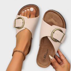 Beige sandals with gold buckle and textured cork sole, open-toe slide