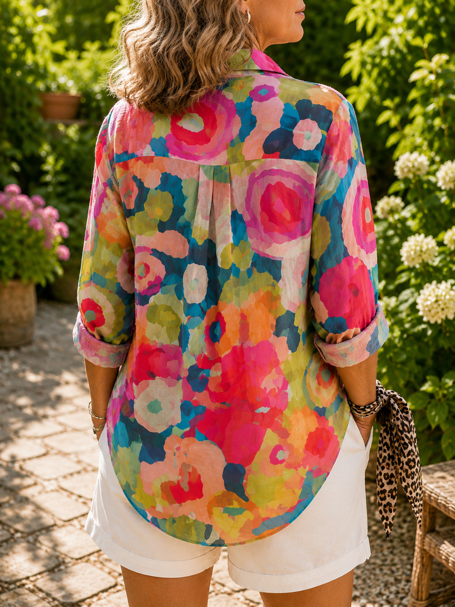 Colorful abstract button-up blouse with rolled 3/4 sleeves and curved back hem