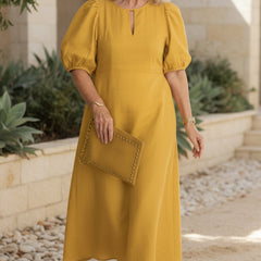 Mustard maxi dress with puff sleeves and keyhole neckline, gathered waist.