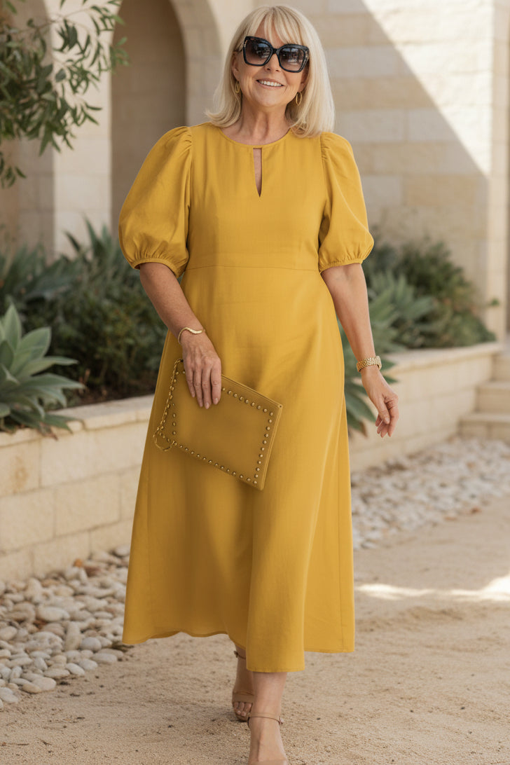 Mustard maxi dress with puff sleeves and keyhole neckline, gathered waist.
