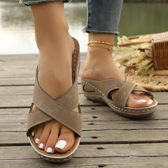 Beige open-toe slingback sandals with crisscross strap and stitched sole
