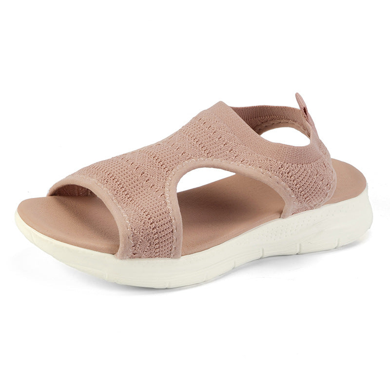 Blush pink knit slide sandals with open toe, cutout upper, and white cushioned sole