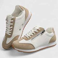 Cream and beige comfort sneakers with lace-up front, side zipper, and tan rubber sole