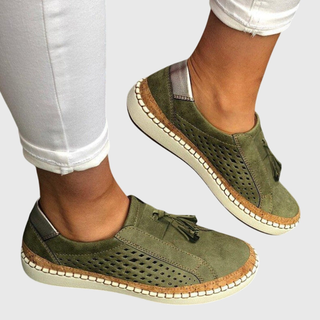Green perforated comfort slip-on shoes with tassel detail and tan stitched sole
