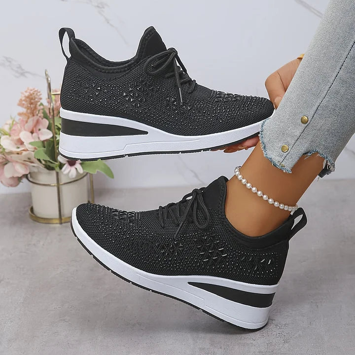 Black knit comfort sneakers with lace-up closure, rhinestone upper, and white sole