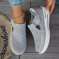 Gray perforated comfort sneakers with side cutout, elastic strap, and white sole