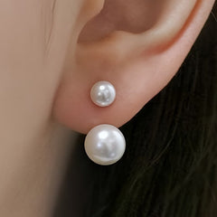 Double-pearl stud earrings with two white pearls stacked on silver posts