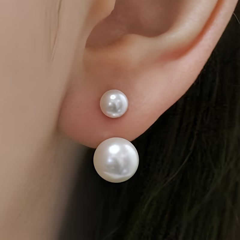 Double-pearl stud earrings with two white pearls stacked on silver posts