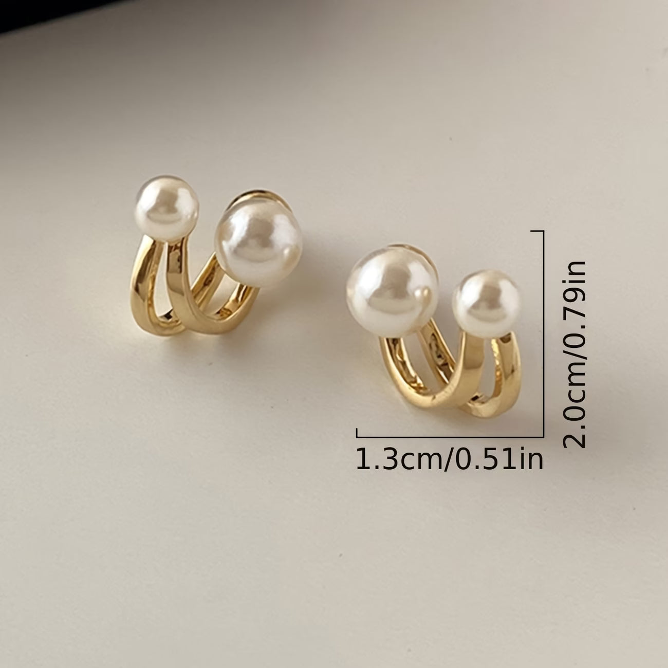 Twisted pearl statement earrings, gold-tone hoops with three white pearls