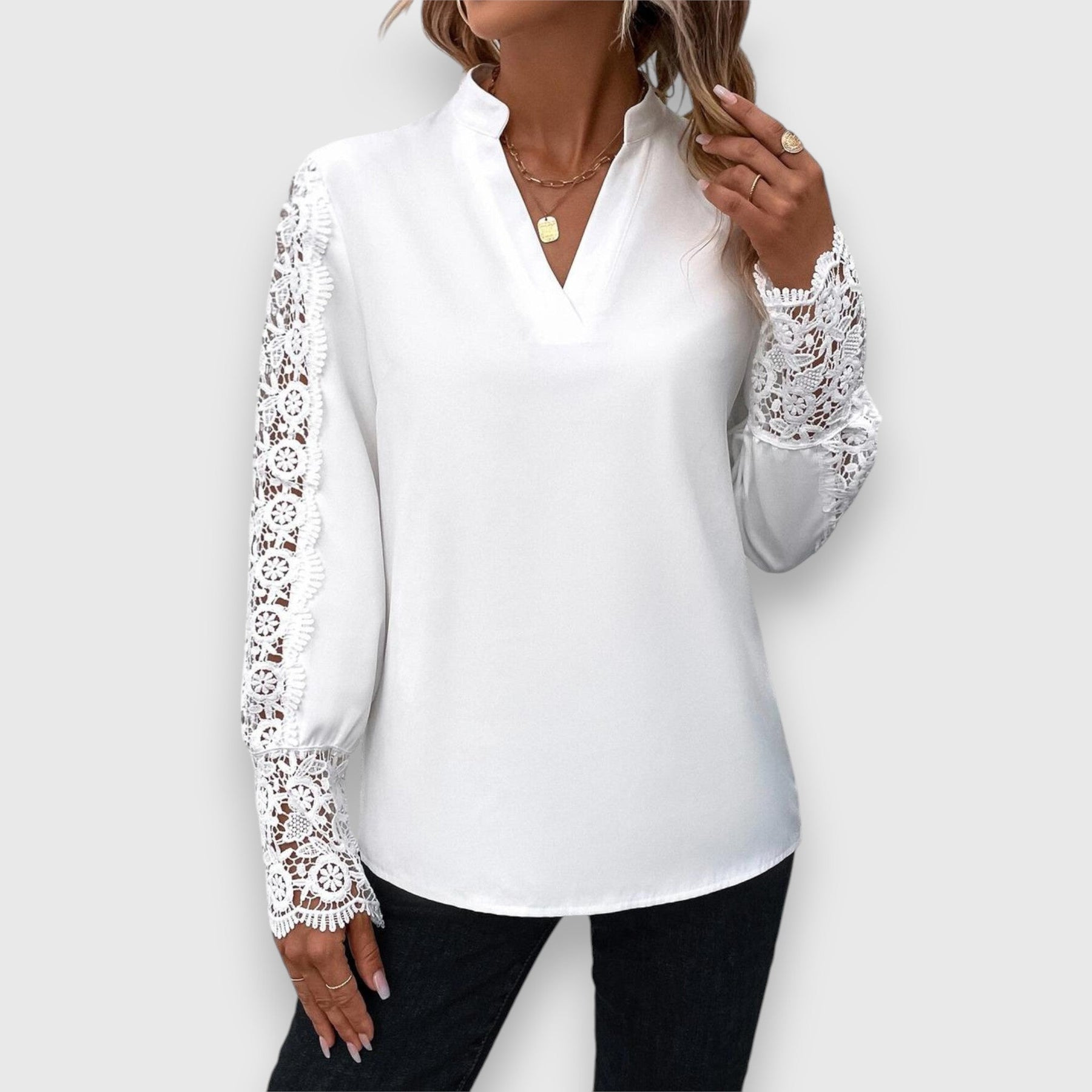 White long-sleeve blouse with lace sleeves and V-neck front
