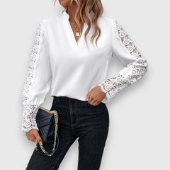 White long-sleeve blouse with lace cuff details and V-neck