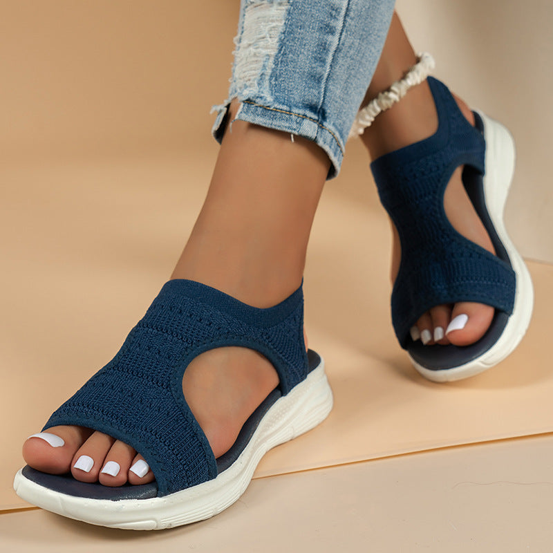 Navy blue knit slide sandals with open toe and white cushioned sole