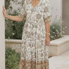 Soft beige bohemian dress with V-neck, short sleeves, tiered floral print.