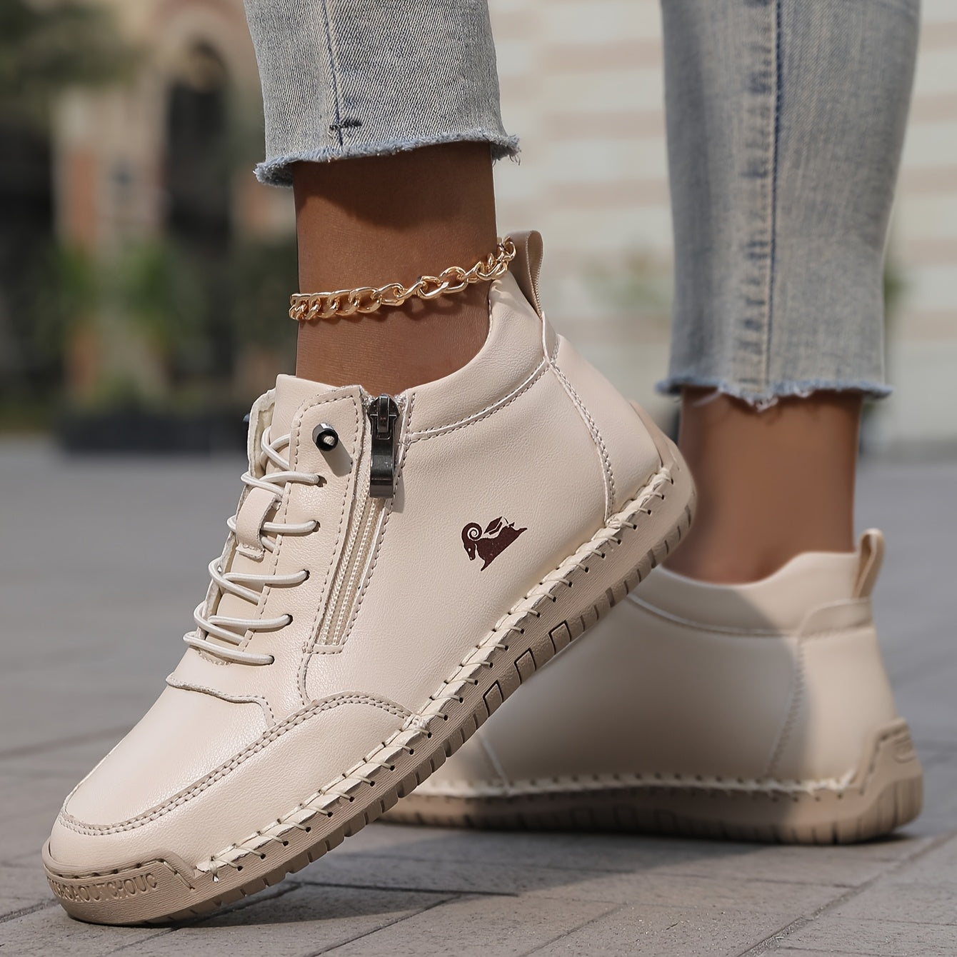 White zip-up comfort shoes with lace-up front and side zipper, gold chain detail