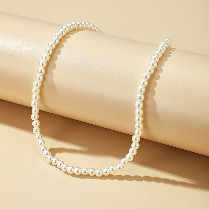 Pearl bead rope necklace laid out flat, round beads and smooth finish