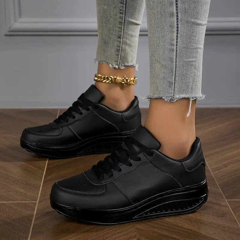 Black lace-up platform comfort sneakers with low-profile tongue and thick sole