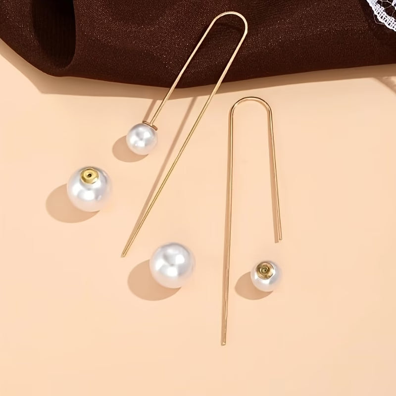 Gold-tone pearl drop earrings with round white pearl beads and thin hooks
