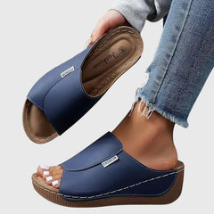 Blue wedge sandals with wide strap and open toe, stitched detail and textured sole