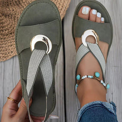 Green flat sandals with mesh strap and round gold-tone metal buckle