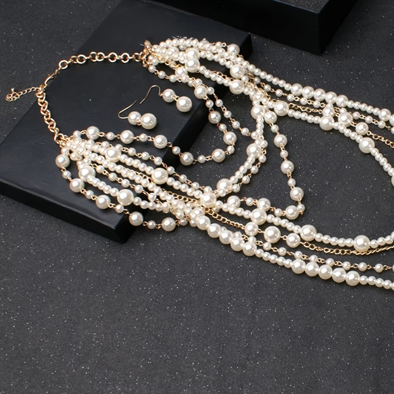 Boho multi-strand pearl necklace with gold-tone chain clasp and dangling loops