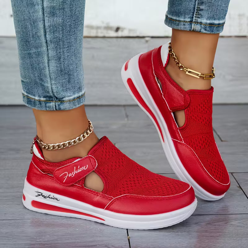 Red slip-on comfort sneakers with knit upper, white sole, oval logo patch