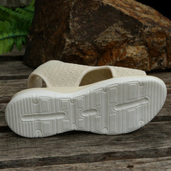 Beige sandal outsole with textured tread, white sole base