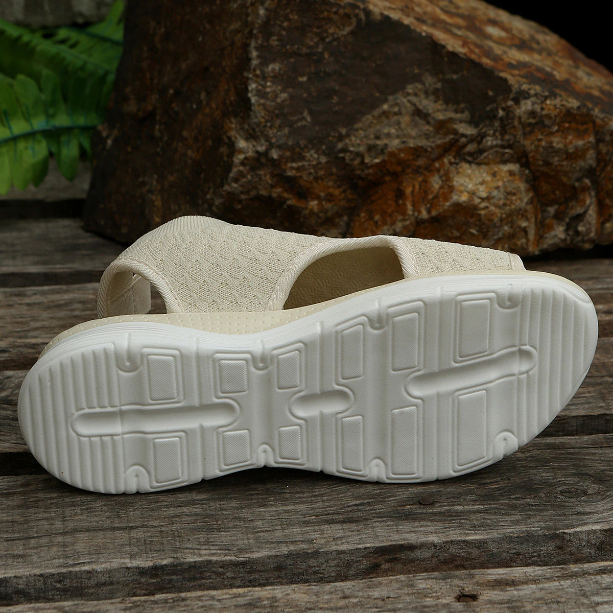 Beige sandal outsole with textured tread, white sole base