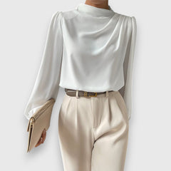 White long-sleeve satin blouse with pleated shoulder detail and high neckline