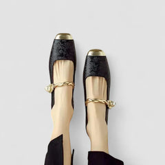 Orthopedic shoes, black textured upper with gold toe and heel caps, ankle bow strap