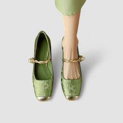 Pair of green orthopedic Mary Jane shoes with adjustable strap and low block heel