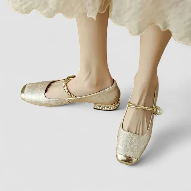Beige orthopedic Mary Jane flats with gold strap and low block heel, decorative heel trim