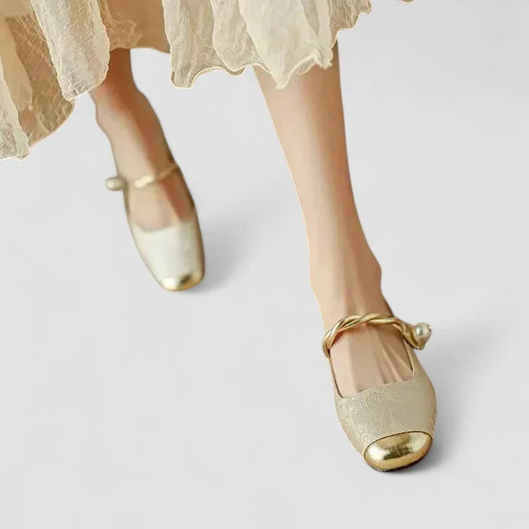 Beige orthopedic Mary Jane shoes with gold strap and low block heel, worn with tulle dress