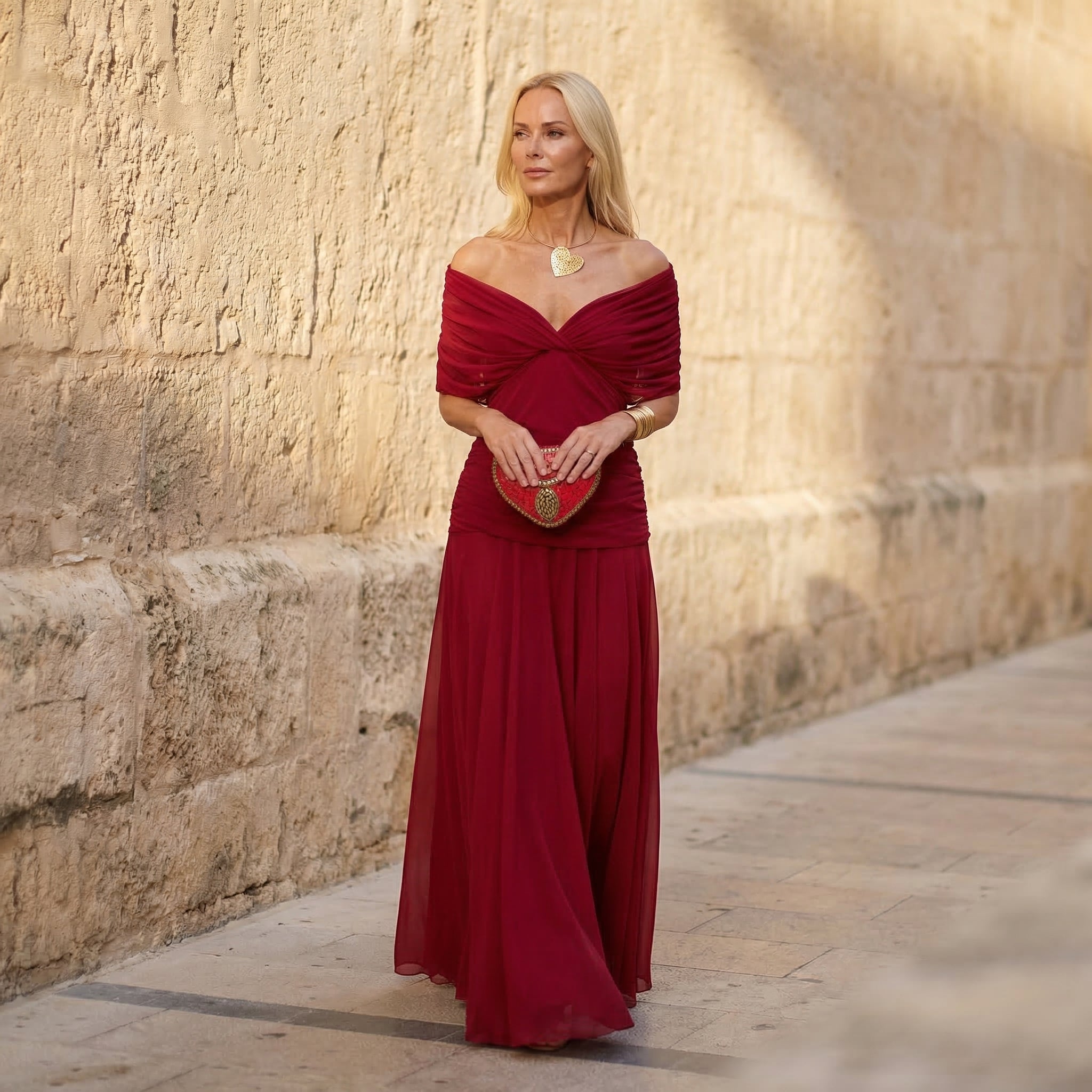 Red off-shoulder chiffon dress with twist neckline and long flowing skirt