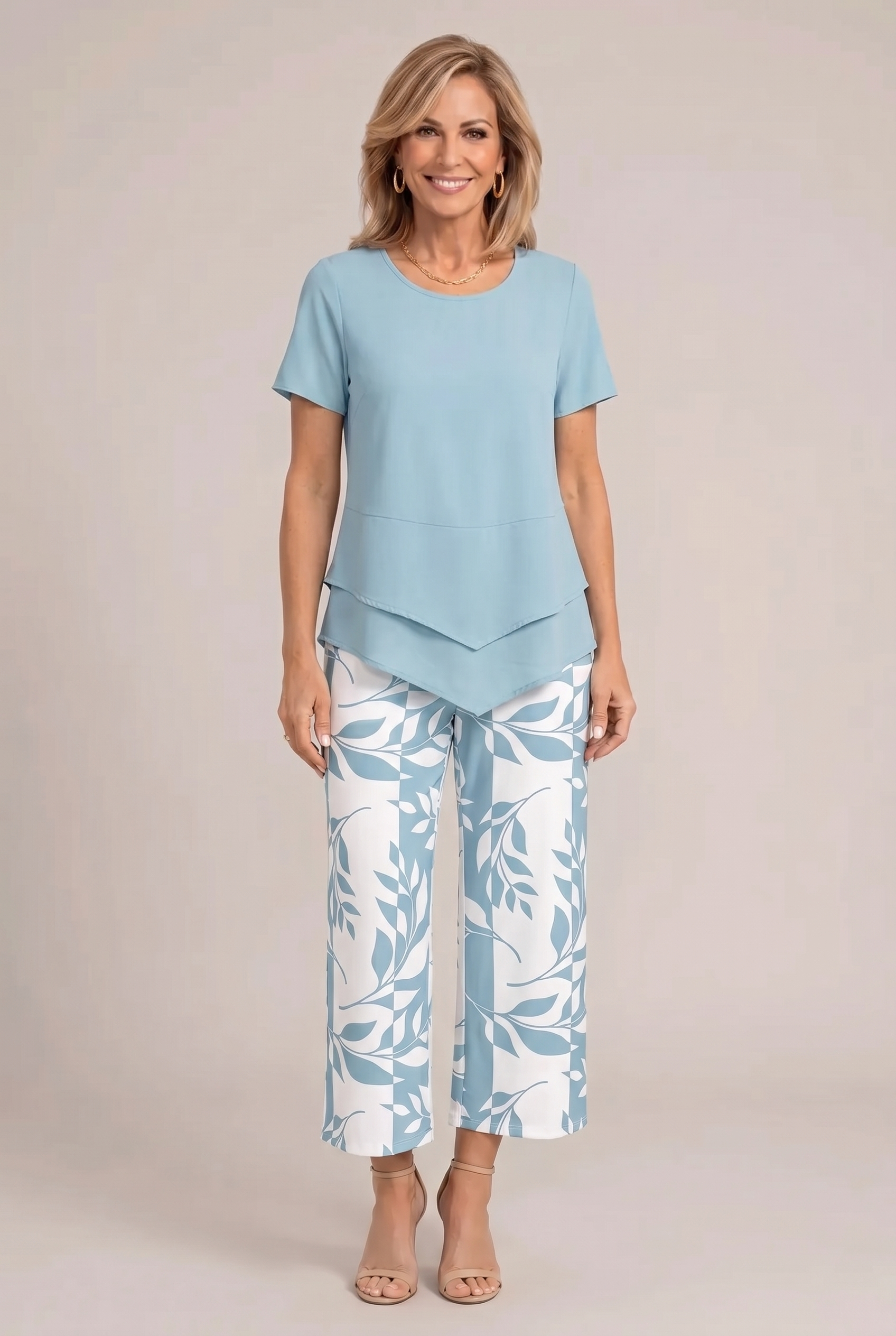 Light blue tailored two-piece set with peplum-style top and white leaf print wide-leg pants