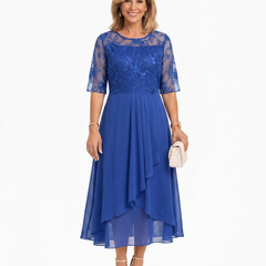Blue lace midi dress with short lace sleeves, fitted waist, and asymmetric ruffle skirt