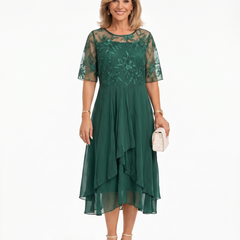 Green lace midi dress with short sleeves, fitted waist, and layered chiffon ruffle hem