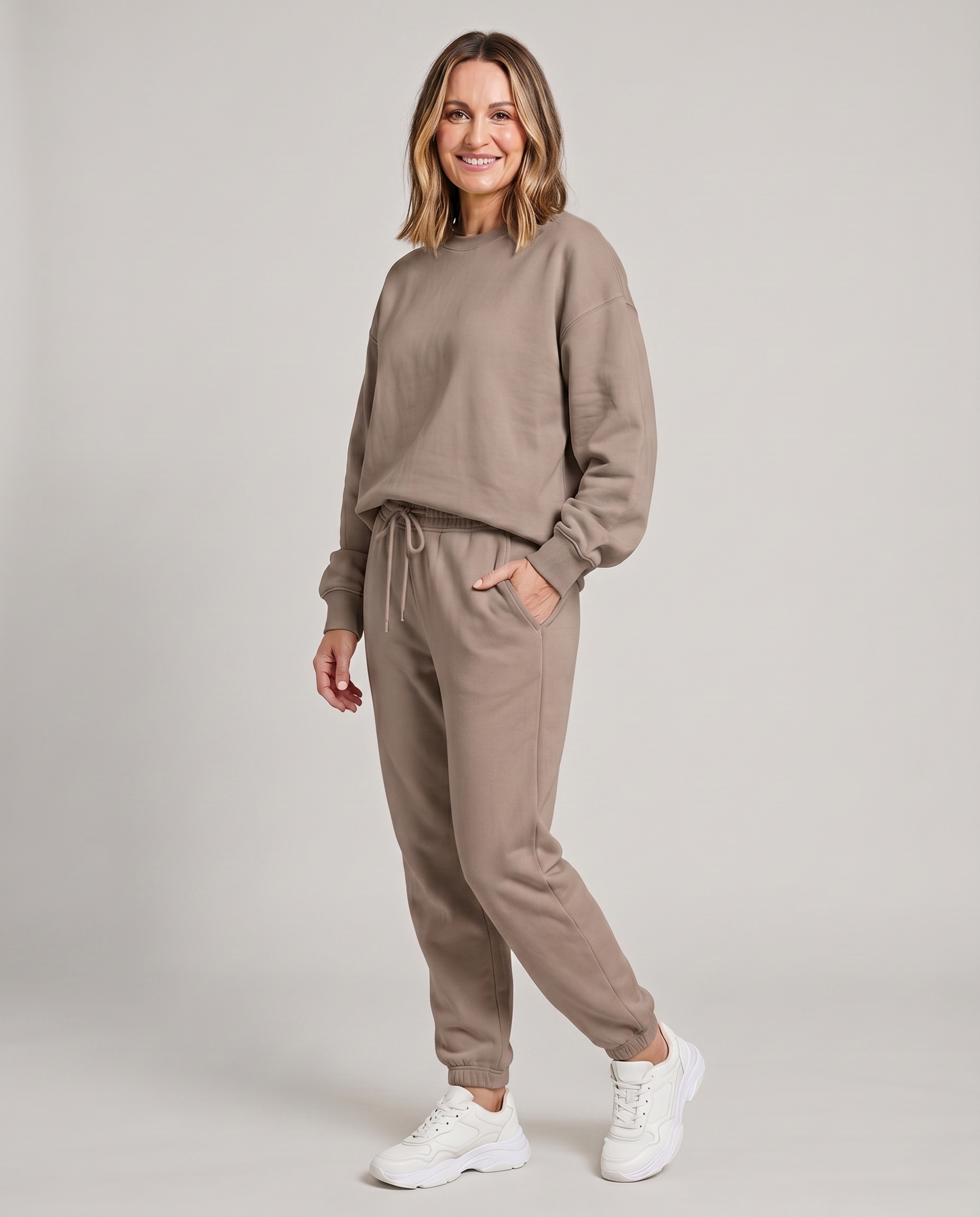 Solid round-neck sweater and drawstring trouser set in taupe.