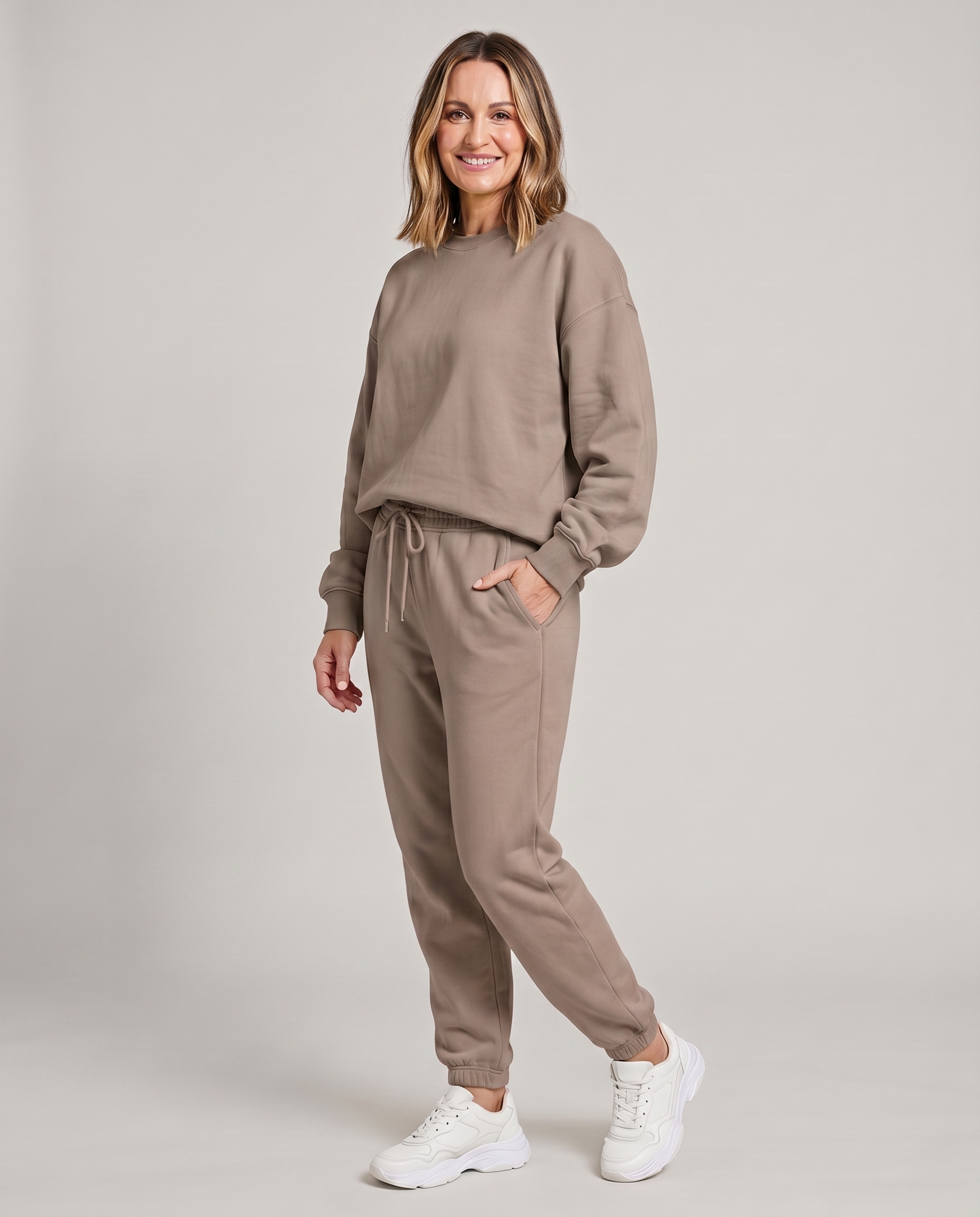 Solid round-neck sweater and drawstring trouser set in taupe.