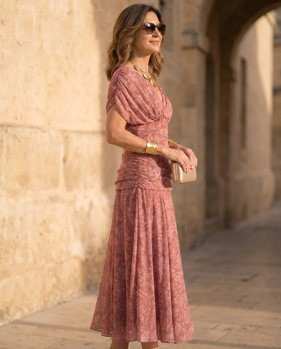 Pink V-neck wrap midi dress, ruched waist and pleated flowing skirt, side view