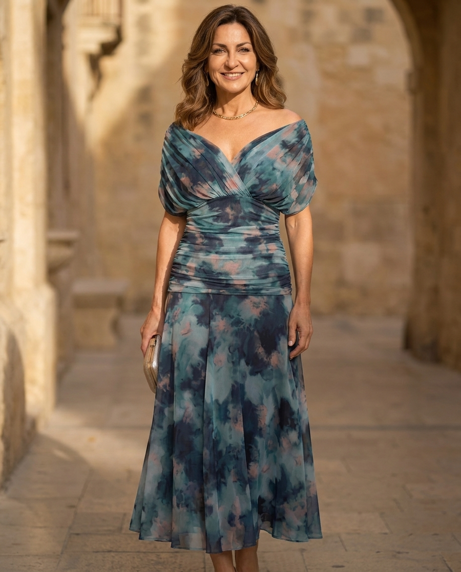 Blue watercolor midi dress with twist front, short sleeves, and gathered skirt