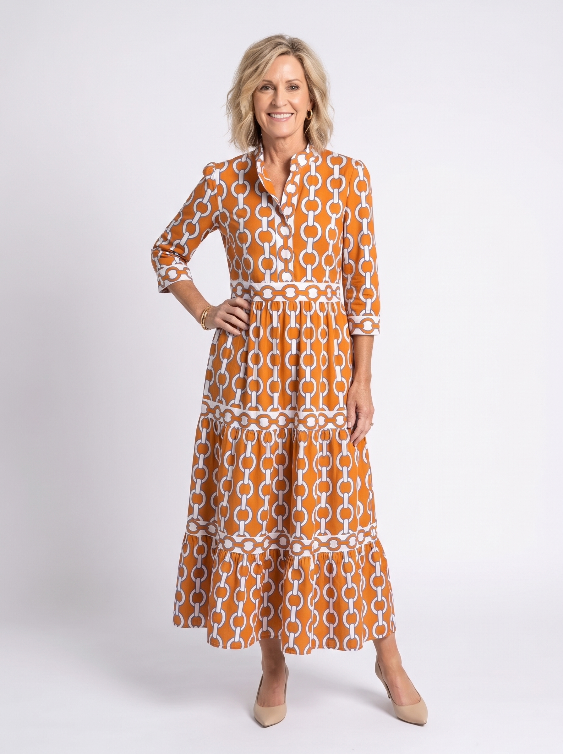 Orange and white chain-link pattern midi dress with 3/4 sleeves and tiered skirt