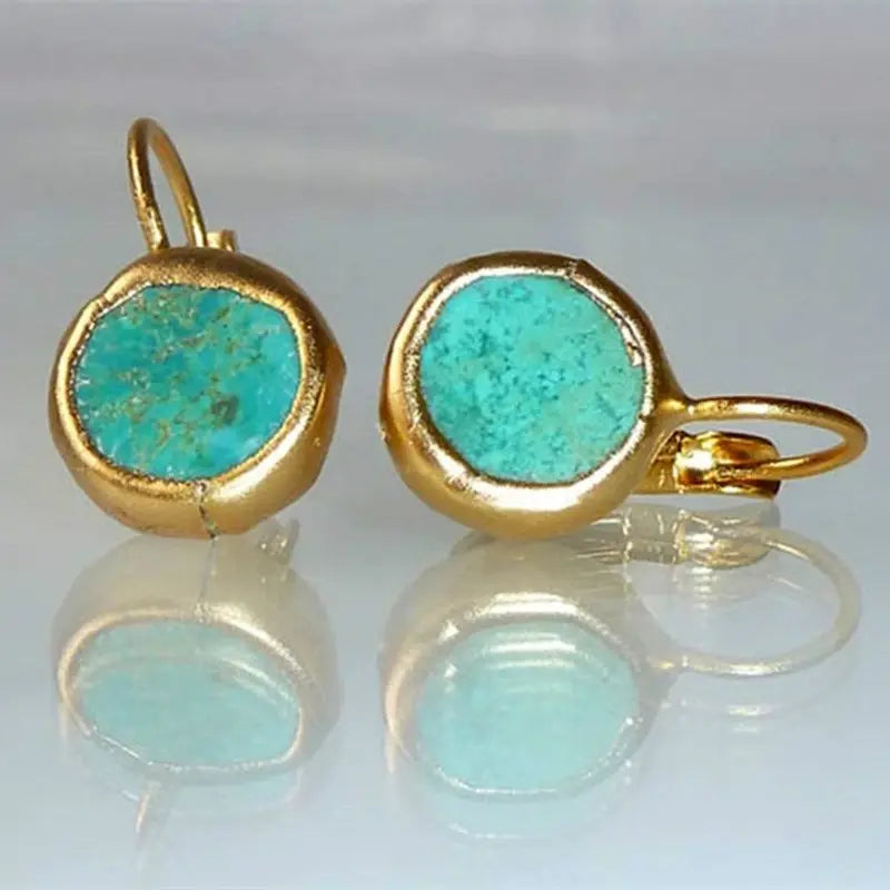 Gold-tone earrings with round turquoise stone bezel and hinged hook backs