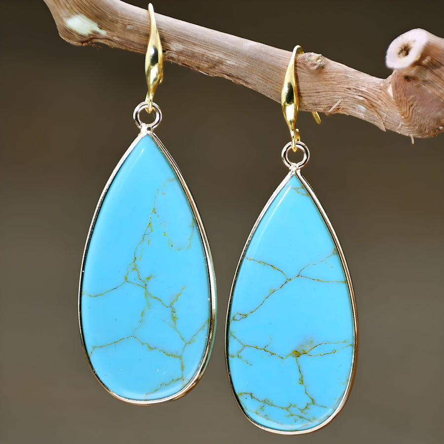Turquoise teardrop drop earrings with gold-tone hooks and wire-framed stone