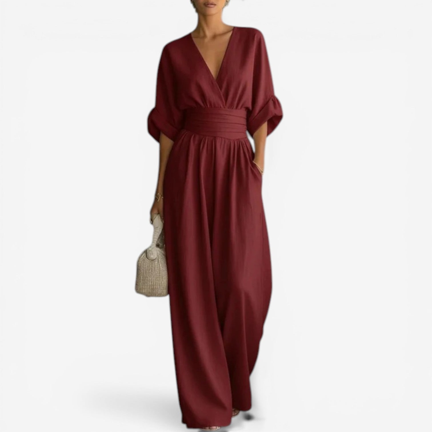 Burgundy V-neck jumpsuit with gathered waist and wide-leg silhouette.