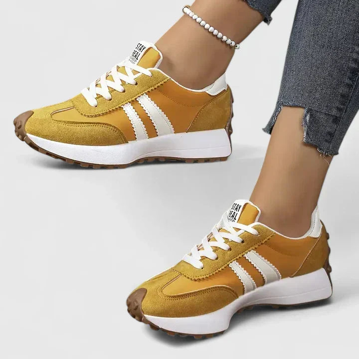 Brown-gold comfort sneakers with white side stripes and lace-up front, chunky sole
